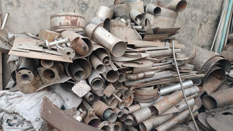 Industrial metal scrap pile showing pipes and sheets